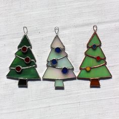 three small stained glass christmas trees