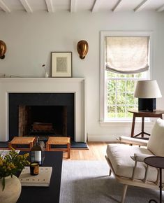 a living room filled with furniture and a fire place