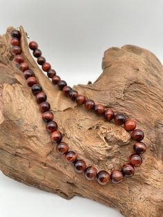 Name Natural  Red Tiger eye Stone Round beaded necklace available in 6 mm 8 mm 10 mm Necklace for men and women Origin Brazil Size Detail Dear customer you can select a size in the option we can add just the necklace for you exactly the same size we accept order Customization as well please let me know if you have any special requirements you can write in the note after placing order thank you======= SHIPPING METHOD AND DELIVERY TIME=======• All items are packaged very carefully and shipped with Brown 8mm Beads Necklace For Gift, Brown Beaded Necklaces As Gifts, Tigereye Stone, Glass Pendent, Round Bead Necklace, Red Tiger, Red Tigers Eye, Tourmaline Necklace, Tiger Eye Stone