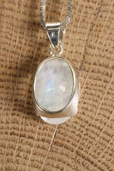 Faceted Moonstone Pendant Approx. Dimensions: 20x14x8 mm This pendant is made with .925 Sterling Silver. Chain is not included. Moonstone is a captivating and enchanting gemstone known for its iridescent play-of-color, which gives it a soft and luminous glow reminiscent of moonlight. It is a type of feldspar mineral with the chemical composition (Na,K)AlSi3O8 and belongs to the same family as other feldspar gemstones like labradorite and sunstone. The most distinctive feature of moonstone is its White Moonstone Oval Pendant, White Moonstone Oval Pendant Jewelry, Iridescent Moonstone Pendant Jewelry, Oval Moonstone Gemstones With Spiritual Style, White Oval Jewelry With Moon Charm, Stone Pendant Design, Moon Stone Pendant, Feldspar Mineral, Blue Moonstone