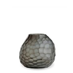 a gray vase sitting on top of a white table