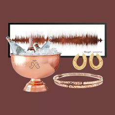 two champagne bottles in a copper bowl with gold hoop earrings