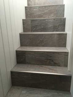 a set of marble steps leading up to a door