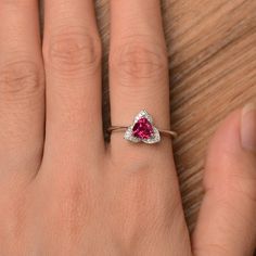 It is a lab ruby ring. The main stone is 6mm*6mm trillion cut, weight about 0.95 carats. The basic metal is sterling silver and plated with rhodium. To change the metal to a solid gold (white/rose) or platinum is also available, please ask for a quotation if you want. You can also go to my shop Home for more elegant rings: https://www.etsy.com/shop/godjewelry?ref=hdr_shop_menu More ruby rings: https://www.etsy.com/shop/godjewelry?ref=hdr_shop_menu&section_id=20709238 Customization is always Trillion Cut Birthstone Ring For Promise, Trillion Cut Birthstone Promise Ring, Trillion Cut Gemstone Birthstone Ring For Anniversary, Trillion Cut Birthstone Ring For Anniversary, Silver Trillion-cut Birthstone Ring, Silver Trillion Cut Ring With Birthstone, Silver Trillion Cut Birthstone Ring, Trillion Cut Rings For Valentine's Day Promise, Red Heart Cut Sterling Silver Birthstone Ring