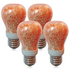 four light bulbs with orange glitter on them