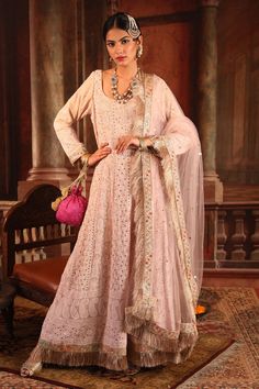 Light pink anarkali kurta with all-over chikankari embroidery and badla-mukaish work. Comes with chanderi pants and sheer net fringe border dupatta.
Component: 3
Embroidered
Neckine: Round
Sleeve Length: Full
Fabric: Kurta: Georgette; Pant: Chanderi; Dupatta: Net
Color: Pink
Fringe hem and border dupatta
Deep U-back
Note: Potli bag shown in the image is not for sale - Aza Fashions Unstitched Anarkali Set With Intricate Embroidery, Anarkali Set With Intricate Embroidery In Georgette, Festive Anarkali Set With Intricate Embroidery, Long Anarkali Set With Intricate Embroidery For Festivals, Intricate Embroidered Anarkali Set For Festivals, Anarkali Traditional Wear With Intricate Embroidery, Traditional Chikankari Embroidery Lehenga Maxi, Anarkali Sets With Chikankari Embroidery For Reception, Floor-length Churidar With Chikankari Embroidery For Reception