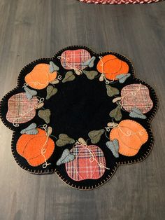 a black and orange rug with pumpkins on it