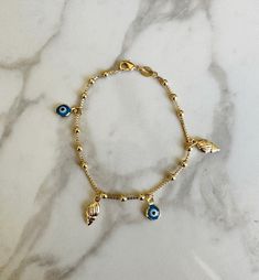 "Perfect worn on its own or layered with our other bracelets. 18k gold filled.  7\" length *18k gold filled is a more affordable alternative to solid gold jewelry. Gold filled is a layer of gold bonded onto a base metal with heat and pressure that contains 100+ times more gold than gold plated jewelry.  *It is very durable and tarnish resistant.  *With proper care, gold filled jewelry can last several years. Avoid contact with harsh chemicals, perfumes, water, etc.  *Gold filled jewelry can be worn by people with sensitive skin because it is hypoallergenic, lead free and nickel free." Sea Shell Bracelet, Sea Shell Jewelry, Fantasy Earrings, Bracelet Evil Eye, Jewelry Beach, Seashell Jewelry, Snake Jewelry, Bracelet Dainty, Dainty Bracelet