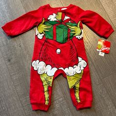 Grinch Onesie Makes A Baby Look Like An Adorable Santa Grinch Holding A Gift 6/9 Months Nwt, 60% Cotton, Soft Red Onesie For Playtime In Winter, Red Winter Onesie For Playtime, Playful Red Onesie For Playwear, Red Cotton Long Sleeve Onesie, Red Long Sleeve Cotton Onesie, Red Cotton Holiday Onesie, Red Playful Winter Onesie, Red Long Sleeve Onesie For Playwear, Playful Red Winter Onesie