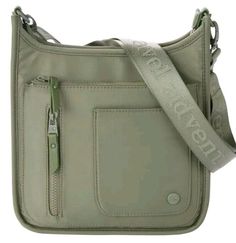 Samantha Brown To-Go Crossbody Bag-Olive-NWT Top Closure: The top zipper is inset with a chunky DTM zipper The front features Samantha Brown round logo plaque Hardware Coated (dyed to match) Removable/Adjustable webbing shoulder strap The exterior front features 2 zip pockets & a slip pocket The exterior back features a back zipper The interior features Signature Lining The interior front wall features a zip pocket & 2 split slip pockets The Interior back wall features a zip pocket Color Choices: Olive Green Measurements: Approx. 10"L x 2.75"W x 11"H Strap Drop: Approx. 15-26" Fiber Content, Shell and Trim: Shell: 100% POLYESTER Trim: 100% POLYURETHANE Fiber Content, Lining: 100% polyester Care: Wipe clean Handbag Style: Crossbody Top Closure(s): Zipper Interior Pockets: Sidewall 4 Exterio Samantha Brown, Medium Sized Bags, Front Wall, Round Logo, Outdoor Activity, Rectangle Shape, Fashion Handbags, Color Choices, Olive Green