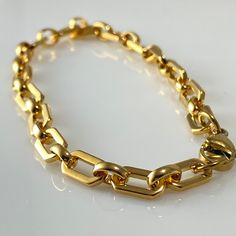 This gorgeous gold plated stainless steel chain has been made into a bracelet. We also have the matching necklace. The feel of this chain is soft and smooth while being substantial and making a statement on its own. Materials: Austrian crystal pearls, silver plated beads, stainless steel chain & findings Measurements: 7 1/2" / 19 cm Weight: 8 gm Why you should love stainless steel: * Waterproof * Hypoallergenic * Non-reactive to sweat, salt & chlorinated water * Rust, corrosion & scratch resista Minimalist Gold-tone Chunky Chain Bracelet, Everyday Gold-plated Stainless Steel Bracelet, Everyday Gold-colored Stainless Steel Bracelet, Gold Stainless Steel Chain Bracelet, Modern Gold-tone Stainless Steel Chain Bracelet, Gold Stainless Steel Chunky Chain Bracelet, Gold Chunky Chain Stainless Steel Bracelet, Gold Stainless Steel Jewelry With Rectangular Links, Trendy Stainless Steel Chain Bracelet With Gold Chain