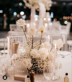 white flowers and candles are on the table