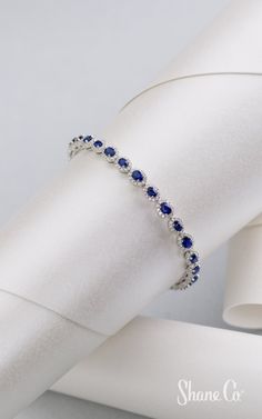 Stunning sapphires are perfect for any occasion. This shimmering bracelet features 28 stunning oval traditional blue sapphires surrounded by 336 round diamonds. Crafted from quality 14k white gold, this contemporary 7″ bracelet is secured with a safety clasp for added security. This bracelet measures approximately 1/4″ wide. Article number: 41083554 Expensive Bracelets, Halo Bracelet, Native American Bracelets, Photo Products, Makeup Stuff, Exclusive Jewelry, Bracelets Jewelry, Blue Jewelry, Diamond Bracelets