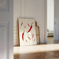 an empty room with a painting on the wall and a wooden floor in front of it