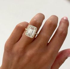 a woman's hand with a diamond ring on it