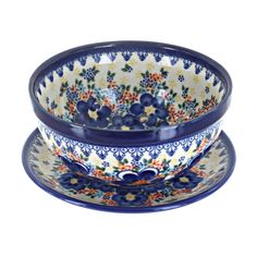 two blue and white bowls sitting on top of each other, one with an orange flower design