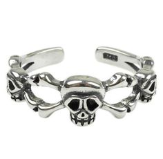 a skull and crossbones bracelet with black stones on the bottom, in silver