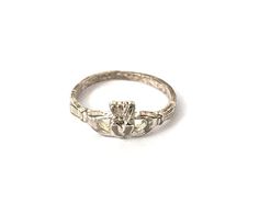 Claddagh Irish Heart Crown Sterling Silver Ring Sz 4 Estate Jewelry Pre-Owned Type: Ring Size: 4 Width: 6 mm Weight: 1.2 gr Hallmark: .925 LL Condition: Well loved ring with scattered scratch and patina. It would be easy to polish up Comments: This ring can be re-sized, it's very petite now and lightweight Please see all photos for details Irish Heart, West Sacramento, Heart Crown, Claddagh Ring, Claddagh Rings, Irish Jewelry, Estate Jewelry, Rings Statement, Sterling Silver Ring