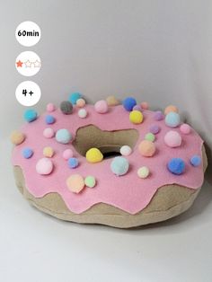 a pink donut with sprinkles on it