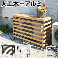 an air conditioner sitting on top of a wooden crate in front of a building