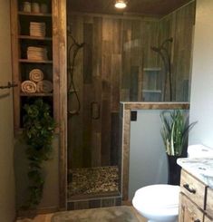 a bathroom with a sink, toilet and shower stall in the middle of it's room