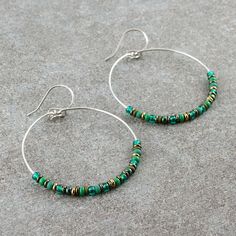 "Beaded hoop earrings. The hoops are carefully handmade of 316L stainless steel, then decorated with various Czech and Japanese glass seed beads. They are dangling from handmade, 316L stainless steel ear wires. COLORS: emerald green, forest green, olive, bronze and hematite SIZE: approx. diameter: 1.6\" / 4 cm Click here for more beaded hoop earrings: www.etsy.com/shop/LianuDesign?ref=seller-platform-mcnav%C2%A7ion_id%C2%A7ion_id&section_id=26956662 Or check out all items in the shop: www.etsy.c Nickel-free Heishi Bead Hoop Earrings, Nickel-free Hoop Earrings With Heishi Beads, Nickel-free Heishi Beads Earrings, Nickel-free Small Hoop Heishi Bead Earrings, Hoop Earrings With Beads, Earrings With Beads, Emerald Green Earrings, Dangle Hoop Earrings, Green Forest