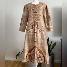 Vintage Handmade Raw Silk Embroidered/Appliqu Ethnic Caftan. Beautiful Champagne Colored Background With In Color With Orange, Brown, & Beige Embroidery/Applique Throughout The Front & On The Puff Sleeves. It Closes With Hook & Eye Closures At The Front With Faux Buttons Details. The Dress Is In Great Vintage Condition With No Noted Flaws Such As Stains Or Holes. No Size Tag, But Would Best Fit A Modern Large, Extra Large Or 2xl (Depending On The Fit You Want). Measurements: Shoulder To Shoulder-16” Bust/Armpit To Armpit-20” Waist-19” Length/Shoulder To Bottom-44” Hips-25.5” Sleeves-20” ***All Measurements Taken With Item Laying Flat & Should Be Doubled Where Needed*** Pleas Beige Embroidery, Colored Background, Embroidered Applique, Champagne Color, Orange Brown, Hook Eye, Embroidered Silk, Raw Silk, Brown Beige