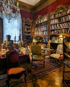 a living room filled with lots of books and furniture