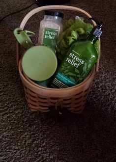 a basket filled with green items on top of a carpet next to a laptop computer