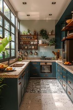 a kitchen with blue cabinets and marble counter tops is seen in this image from the inside