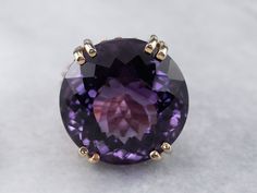 This setting is a true classic! Considered the height of fashion in the Mid Century era, the lines of this simple solitaire are clean and well balanced, providing a sophisticated look! We've set this vintage setting with a gorgeous amethyst. A bright regal purple hue, this sparkling stone glitters with intense fire from every facet. Metal: 14K Yellow Gold Gem: Amethyst 37.29 Carats Gem Measurements: 21.4 mm, Round Ring Size: 8 SKU #: HRRC19ZC Each piece has been identified and graded by a Gradua Luxury Antique Amethyst Ring For Women, Yellow Gold Amethyst Ring, Vintage Setting, Amethyst Cocktail Ring, Gold Amethyst Ring, Right Hand Ring, Crystal Goddess, Three Stone Diamond, Right Hand Rings