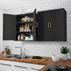 a kitchen with black cabinets and white subway backsplash