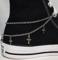 "This shoe or boot chain design features two chain strands with two styles of metal cross charms attached along the bottom chain. This design is available in Dark Silver (the chain is stainless steel). This listing is for 1 shoe (or boot) chain.  If you want chains for both shoes (or boots) you will need to order 2. There are 3 different ways to attach the chains to your shoe or boot. Below is the type of attachment and the length of each chain for that way. It is a good idea to measure your shoes or boots first to make sure the chain will fit. Jump Ring Ends to slip onto the laces - See picture 5. The length of the chain for this is 10 inches for shoes and 12 inches for boots or padded/thick high-tops. *The jump ring size for shoes are 8mm diameter and the jump ring size for boots are 10m Boot Chains, High Top Shoe, Shoe Boot, Metal Cross, Cross Chain, Silver Chain Style, Chain Design, Double Chain, Cross Charms