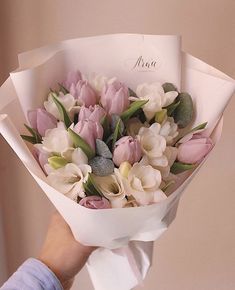 a person holding a bouquet of flowers in their hand