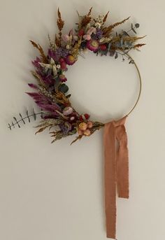 a dried flower wreath hanging on the wall