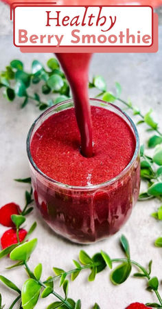 berry smoothie being poured into a glass bowl with strawberries around it and text overlay that reads healthy berry smoothie