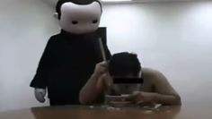 a man taking a selfie with a cell phone in front of him wearing a mask