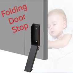 there is a baby sleeping in bed with the text folding door stop