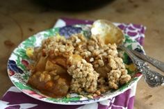 a close up of a plate of food on a table with utensils and napkins