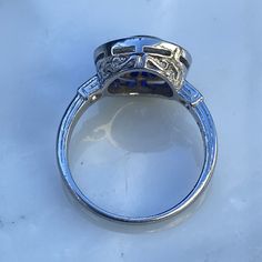 Details: Stunning vintage Art Deco style diamond & sapphire engagement ring. The band is platinum. This is an gorgeous ring with lovely engraving around the shoulders of the band, and has engraving details surrounding the diamond. This ring is stunning! Appraisal Reads: One old European cut diamond, measuring 5.8 x 5.8 x 3.55mm an approx. weight .73ct. with strong blue fluorescences. Clarity VS-2 Color J Cut Very Good Depth 61.2% Table 60.3% Two round brilliant cut diamonds measuring 1.5 x 1 Classic Formal Diamond Ring With Lab-created Sapphire, Classic Sapphire Ring With Bezel Setting, Platinum Sapphire Ring With Vvs Clarity, Art Deco Sapphire Ring With Platinum Center Stone, Vintage Sapphire Ring With Diamond Cut, Oval Shape, Vintage Oval Sapphire Ring With Diamond Cut, Antique Oval Sapphire Ring With Diamond Accents, Vintage Blue Sapphire Ring In Platinum, Vintage Blue Sapphire Ring With Bezel Setting