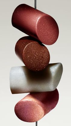 three lipsticks stacked on top of each other