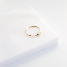 "This beautifully dainty ring is the perfect tiny gemstone stacker! They make wonderful gifts for mothers as you can easily stack multiples, one for each loved one. They also make delicate little promise rings! DETAILS * The stone measures 2mm across. * The band measures approximately 1mm thick. * This ring comes with a cubic zirconia stone. * We can make these in 14k gold filled, 14k rose gold filled, sterling silver, solid 14k yellow gold or solid 14k rose gold. * Each ring is sold separately. April Birthstone Ring, Gifts For Mothers, Mothers Ring, Dainty Gold Rings, Mother Rings, Etsy Gold Ring, April Birthstone, Cz Ring, Dainty Ring