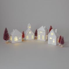 a group of small white houses with lights on them