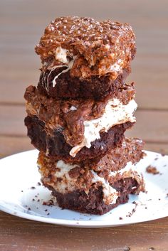 three brownies stacked on top of each other with white frosting and sprinkles