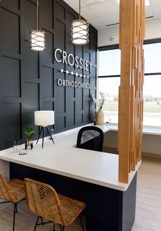 the front desk of crossley orthodnie with two chairs and a lamp