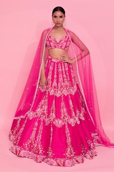 Pink can can attached lehenga with crystal and pearl embellished floral motifs. Comes with matching padded blouse and dupatta.
Components: 3
Pattern: Embellished
Type Of Work: Crystal, Pearl
Neckline: V-neck
Sleeve Type: Sleeveless
Fabric: Lehenga and Blouse: Tussar Silk, Dupatta: Net
Color: Pink
Other Details: 
Attached lining
Lehenga Length: 46.5 inches
Weight: 7.5 kgs
Closure:
Lehenga: Side drawstring
Blouse: Back hook
Occasion: Sangeet,Cocktail - Aza Fashions Crystal Lehenga, Cape Lehenga, Lehenga And Blouse, Kurta Lehenga, Lehenga Pattern, Padded Blouse, Lehenga Skirt, Pink Lehenga, Lehenga Blouse