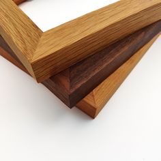 three pieces of wood stacked on top of each other in a square frame with one piece missing