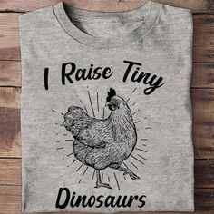 Shipping from the US. Easy 30 day return policy, 100% cotton, Double-needle neck, sleeves and hem; Roomy Unisex Fit. Casual Cotton T-shirt With Dinosaur Print, Casual Dinosaur Print Cotton T-shirt, Casual Cotton Shirt With Dinosaur Print, Funny Cotton Top With Dinosaur Print, Dinosaur Shirts, Tiny Dinosaur, T Shirt Long Sleeve, Green Farm, Chicken Shirts