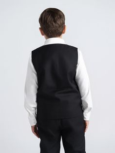 Our tailored black tux vest adds the finishing touches to a 3 piece suit. Buttons can be left button or unbuttoned. Pair with matching black double breasted blazer and black tailored dress pants for a sharp effortless look. Explore Mofi Clothing: meticulously crafted for husky, broader, and stout boys, or any boy who simply needs a bit more room. Our designs prioritize comfort without compromising on style, ensuring every child feels confident and comfortable. Model 1 wearing size 12. Model 2 we Classic Black Vest For Business, Formal Fitted Black Vest, Black Fitted Formal Vest, Black Fitted Vest For Formal Occasions, Classic Black Vest For Tailoring, Classic Black Tailoring Vest, Black Notch Lapel Vest For Business, Black Suiting Fabric Sets For Business Casual, Black Notch Lapel Sets For Black Tie Events