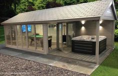 an outdoor jacuzzi in the middle of a yard with a hot tub next to it